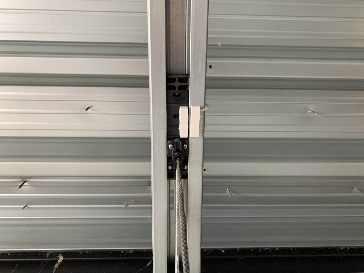 Contact sensor attached to the "pulley" of my garage door opener & metal frame.