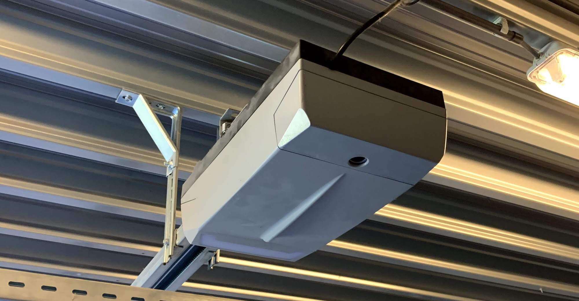 From the outside everything is still the same. Looks like a "dumb" garage door opener.